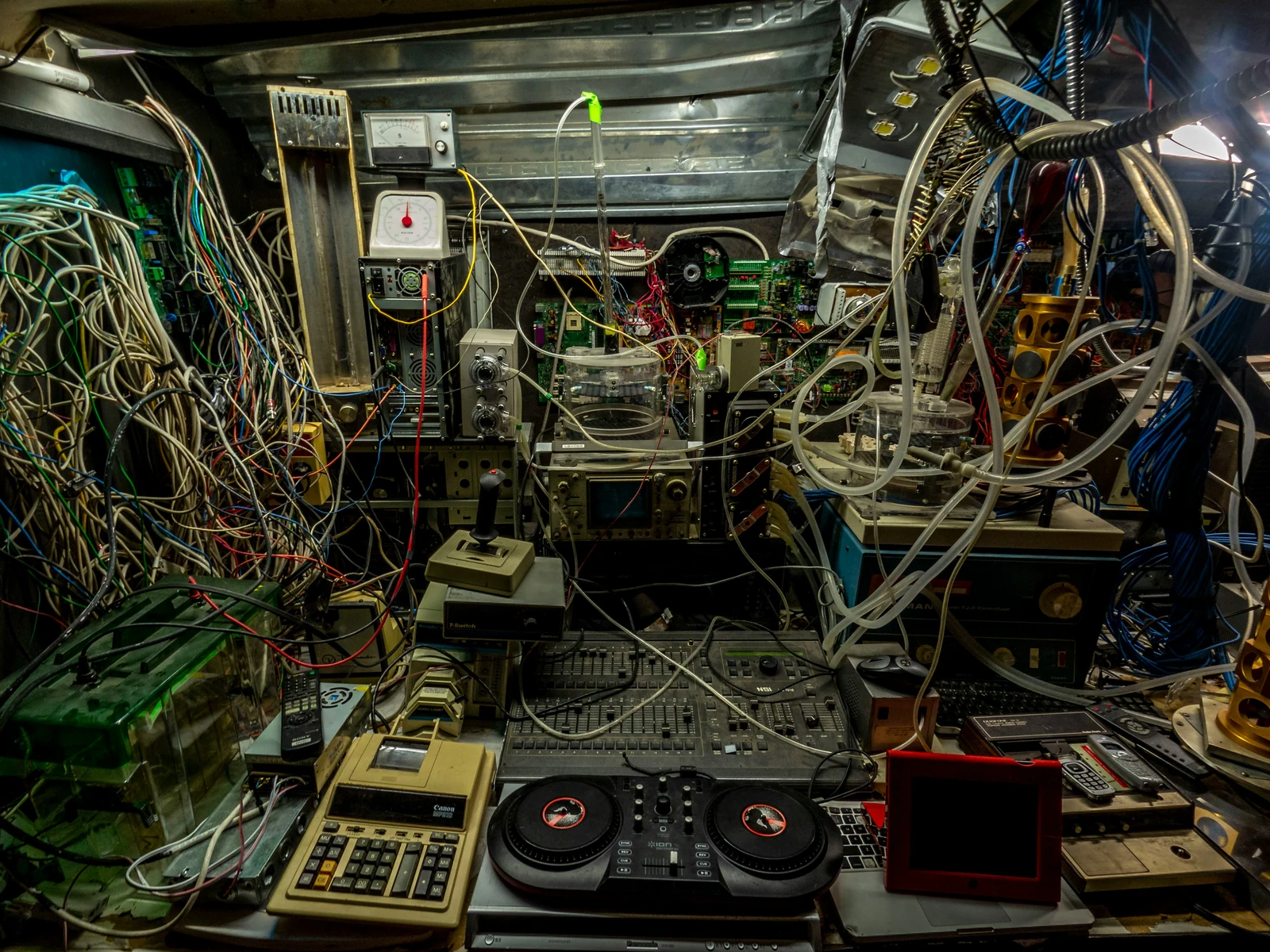 Complex equipment surrounded by tangled cables