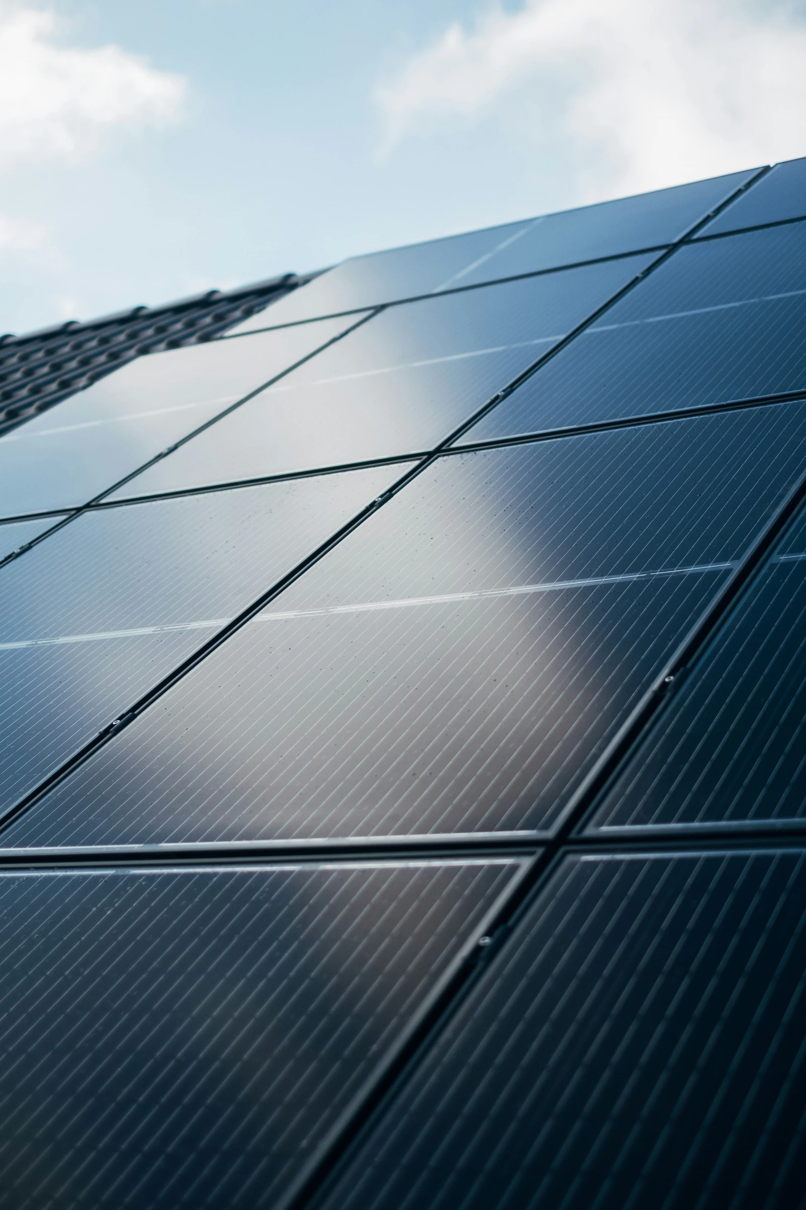 Rooftop solar panels under a bright blue sky